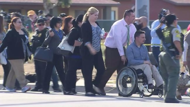 People are escorted away from the scene of a shooting in San Bernardino on Dec. 2, 2015. (CNN)