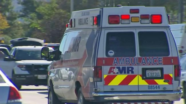 An ambulance leaves an intersection near the scene of a mass shooting at Inland Regional Center in San Bernardino on Wednesday. (CNN)