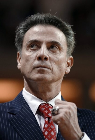 Louisville coach Rick Pitino looks up at the scoreboard during an NCAA college basketball game against College of Charleston during the first half of an NCAA college basketball game in Charleston, ...