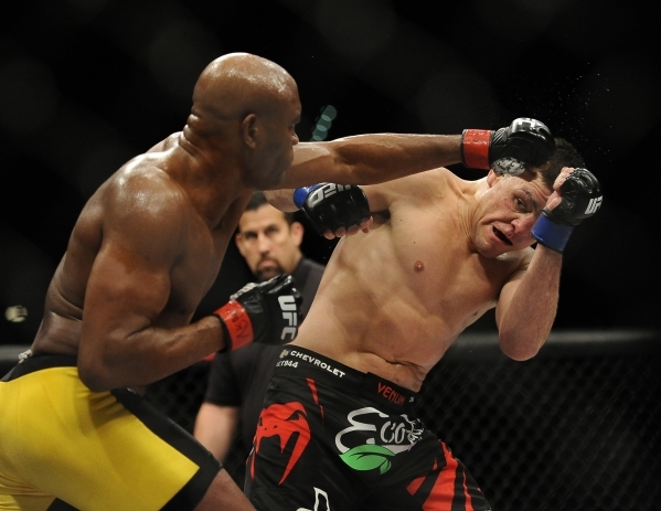 UFC middleweight Anderson Silva, left, fights with UFC middleweight Nick Diaz during their fight at UFC 183 at the MGM Grand Garden Arena in Las Vegas, Saturday, Jan. 31, 2015.(Josh Holmberg/Las V ...