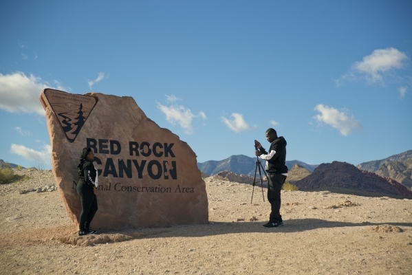 Shannon Everett has her photo taken by Mackendy Dorsainvil at the sign for the Red Rock Canyon National Conservation Area on Monday, Nov. 16 2015. (Daniel Clark/Las Vegas Review-Journal)