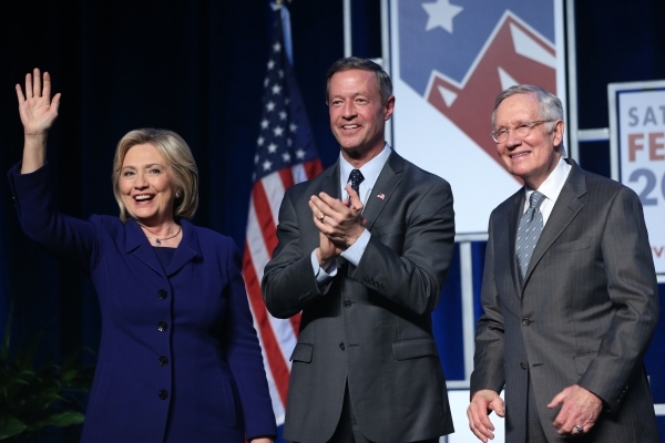 Democratic presidential candidates from left, Hillary Clinton, Martin O‘Malley and U.S. Sen. Harry Reid, pose on stage during the Battle Born/Battleground First in the West Caucus Dinner at  ...