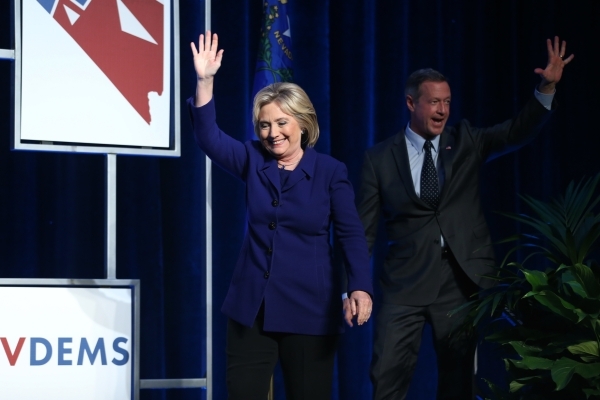 Democratic presidential candidates Hillary Clinton, left, and Martin O‘Malley take the stage during the Battle Born/Battleground First in the West Caucus Dinner at the MGM Grand Conference C ...