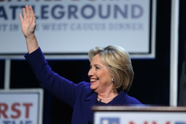 Democratic presidential candidate Hillary Clinton waves at supporters while on stage during the Battle Born/Battleground First in the West Caucus Dinner at the MGM Grand Conference Center on Wedne ...