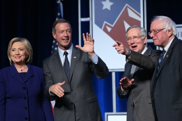 Democratic presidential candidates from left, Hillary Clinton, Martin O‘Malley, U.S. Sen. Harry Reid, and Bernie Sanders pose on stage during the Battle Born/Battleground First in the West C ...