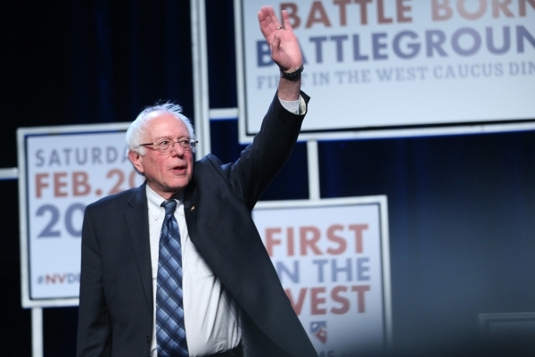 Democratic presidential candidate Bernie Sanders waves at supporters while on stage during the Battle Born/Battleground First in the West Caucus Dinner at the MGM Grand Conference Center on Wednes ...