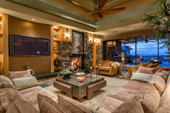 With an alcove ceiling and a large stone fireplace, the living room can accommodate extensive couches and free-standing seats, as well as a dedicated media center wall. It is sided by a northwest- ...