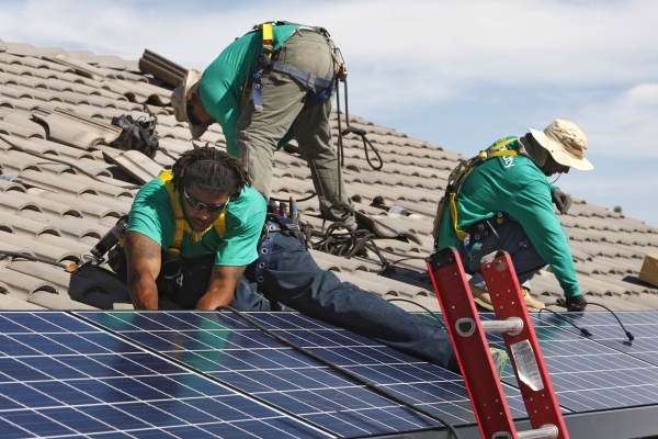 From left, Solar City installation crew leader Greg Kates, Guillermo Aviles and Lyle Bradford install solar panels on a North Las Vegas home Thursday, Oct. 30, 2014. (Sam Morris/Las Vegas Review-J ...