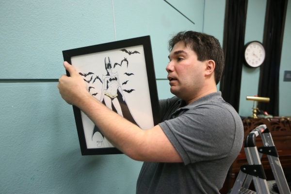 Artist Joshua Weinberg installs one of his drawings for an upcoming gallery show titled Pop Culture Pin Ups at the Green Valley Library on Wednesday, Jan. 30, 2015 in Henderson, Nev. Erik Verduzco ...