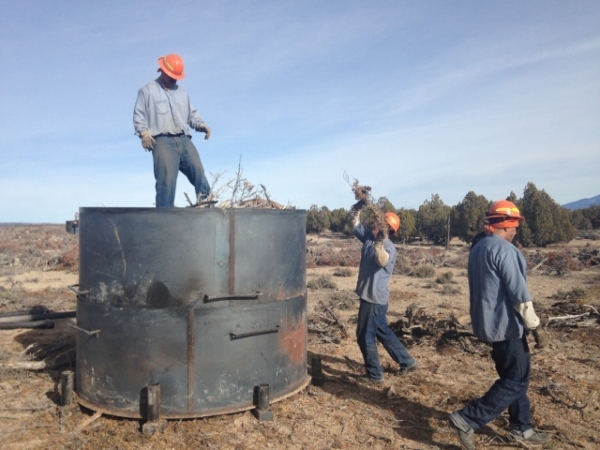 Crews with the Nevada Division of Forestry load a kiln as they prepare to make charcoal from pinion-juniper trees near Ely on Dec. 9, 2015. The process is an experiment on how to utilize forest pr ...