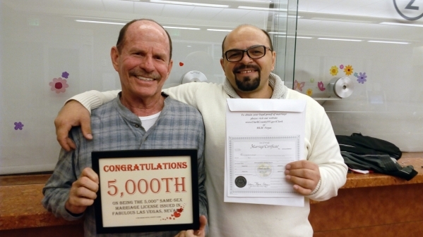 Ronald Bauman and Dumitru Alexeev of Phoenix pose for a photo in Las Vegas on Thursday, Dec. 31, 2015, after they received the 5,000th marriage license issued to a same-sex couple in Clark County. ...