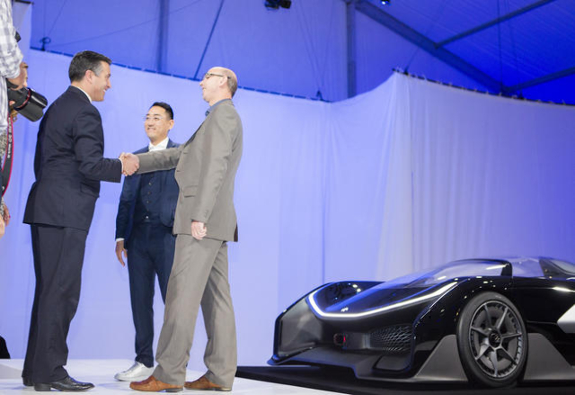 Nevada Gov. Brian Sandoval, left, shakes hands with Faraday Future executive Nick Sampson while Faraday‘s Richard Kim looks on during the unveiling of the FFZero1 prototype at Las Vegas Vill ...