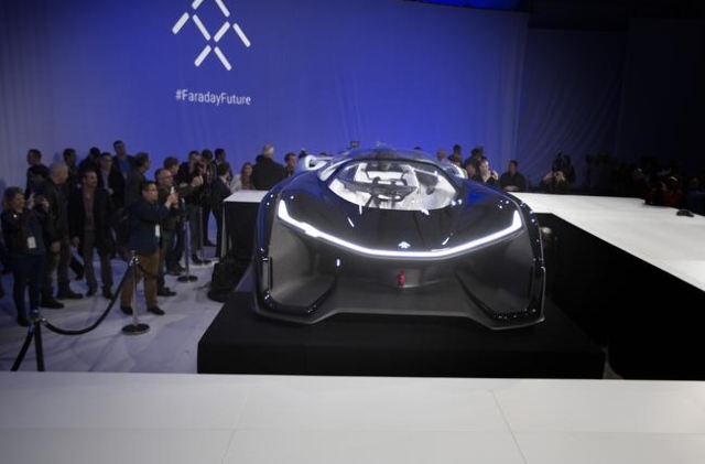 Media and guests gather around the Faraday Future FFZero1 prototype at Las Vegas Village Lot, 3901 Las Vegas Boulevard South on Monday, Jan. 4, 2016. Faraday is scheduled to build a $1 billion pro ...