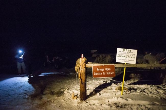Anti-government protesters stand by the entrance of Malheur National Wildlife Refuge, which they are currently occupying, near Burns, Ore. on Sunday, Jan. 3, 2016. The protesters, many of them arm ...