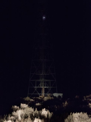 A man with a headlamp climbs the top of a steel tower as anti-government protesters guard the entrance of Malheur National Wildlife Refuge, which they are currently occupying, near Burns, Ore. on  ...