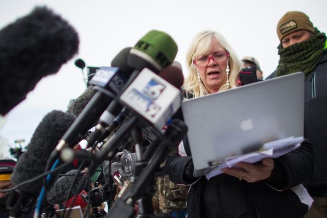 Anti-government protestor Shawna Cox of Utah gives a statement to reporters at a news conference by the entrance of Malheur National Wildlife Refuge near Burns, Ore. on Monday, Jan. 4, 2016. The p ...
