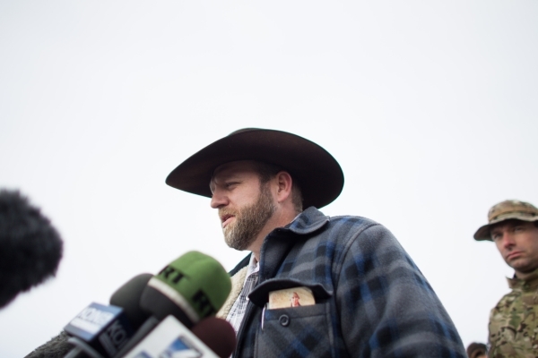 Ammon Bundy, center, speaks with reporters at a news conference by the entrance of Malheur National Wildlife Refuge near Burns, Ore., on Monday, Jan. 4, 2016. Bundy, the son of Nevada rancher Cliv ...
