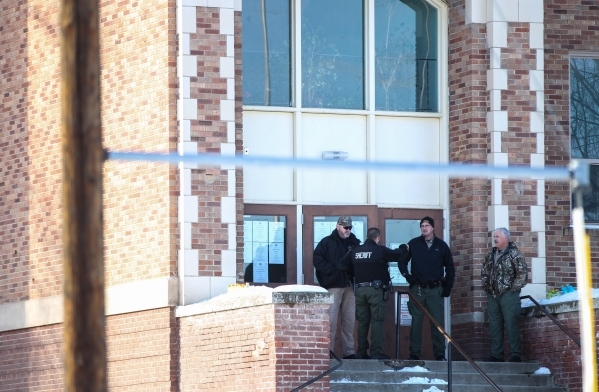 Law enforcement officers stand outside of Lincoln Junior High School before a statement from Harney County Sheriff Dave Ward in Burns, Ore. on Monday, Jan. 4, 2016. Law enforcement has set up at t ...