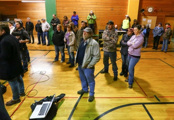Area residents and news media look on during a a news conference held by the Harney County sheriff at Lincoln Junior High School in Burns, Ore. on Monday, Jan. 4, 2016. Law enforcement has set up ...