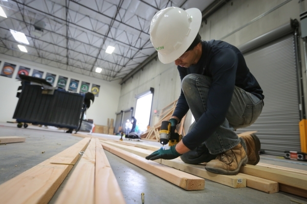 Adam Mentier, 23, of North Las Vegas, dismantles framework at the SolarCity training facility in Las Vegas on Tuesday, Jan. 5, 2016. SolarCity decided to shutter its Nevada-based installation and  ...