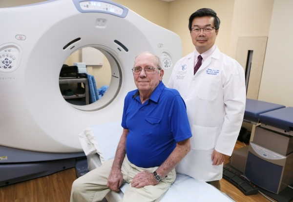 Patient Brian Fong, left, 67, who suffers from Chronic Obstructive Pulmonary Disease, and Dr. James Tsu, who specializes in pulmonary critical care medicine, are shown near a CT Optima 580 scannin ...