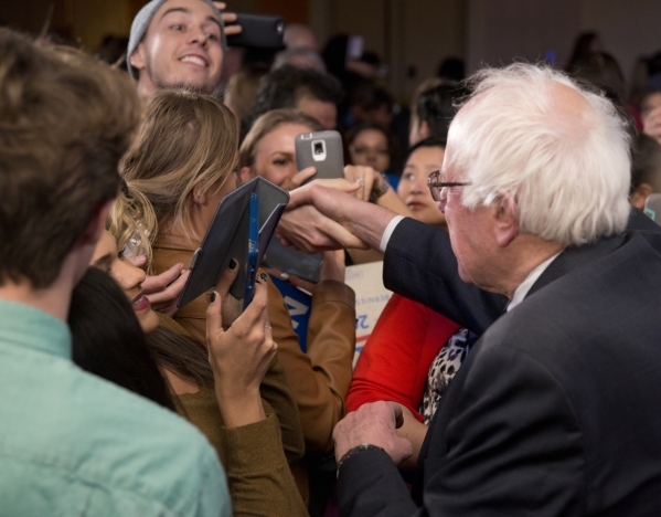 Democratic presidential candidate Sen. Bernie Sanders, I-Vt., shakes hands with a member of the crowd during the "Future to Believe In" rally supporting Sanders inside the Tropicana hote ...