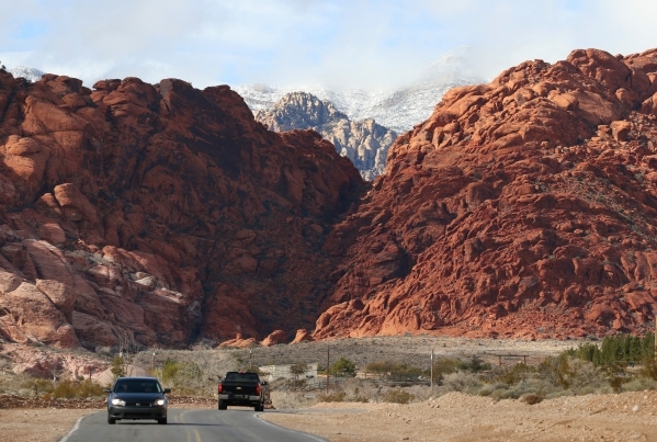 Vehicles make their way along Calico Basin Road near a cloudy and snow-topped Red Rock Canyon National Conservation Area Wednesday, Jan. 6, 2016, near Las Vegas. Ronda Churchill/Las Vegas Review-J ...
