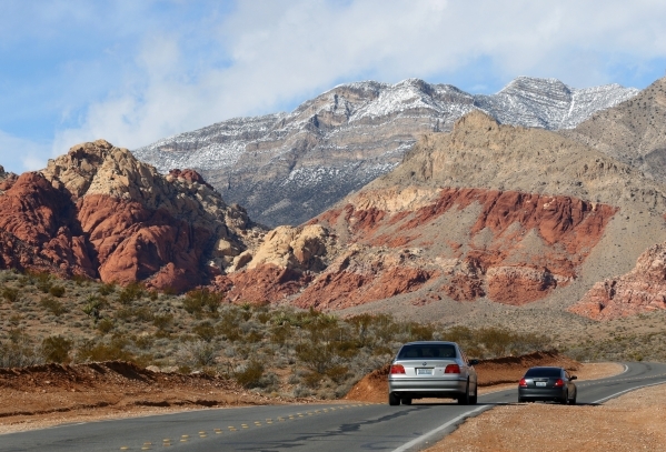 Cars make their way along Calico Basin Road near a cloudy and snow-topped Red Rock Canyon National Conservation Area Wednesday, Jan. 6, 2016, near Las Vegas. Ronda Churchill/Las Vegas Review-Journal