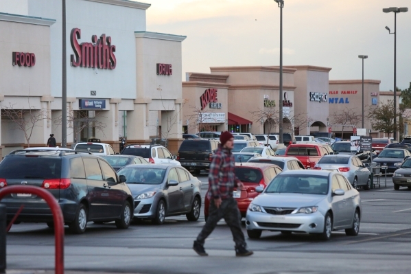 A pedestrian walks across the parking lot of the Smith‘s Shopping Center in Las Vegas on Thursday, Jan. 7, 2016. The Smith‘s Shopping Center, located on the northwest corner of South F ...