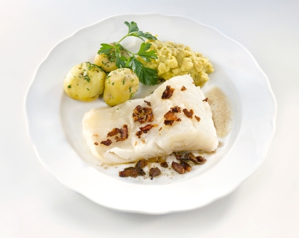 Lutefisk is served here with potatoes and bacon. While once a popular Scandinavian dish, it is now mainly found during ethnic celebrations in church basements and lodge halls in the U.S. (Photo by ...