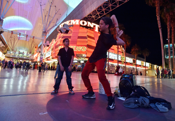Justin Arce, 11, left, and his brother Drew Arce, 15 perform their contortion and dance act at the Fremont Street Experience Monday, Jan. 11, 2016, in Las Vegas. Buskers and street performers are  ...