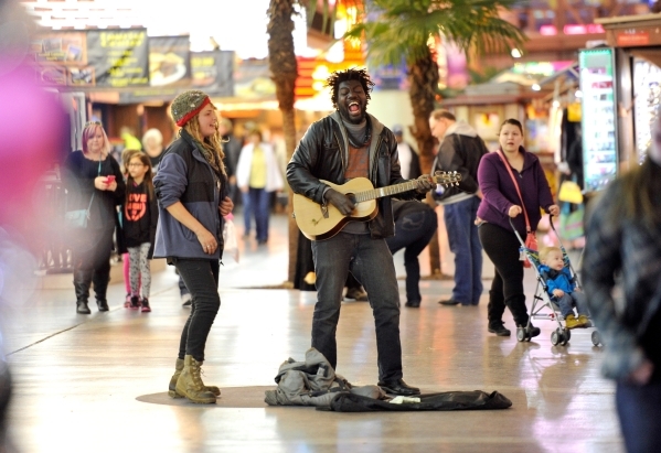 Raskull Jackson, left, and her boyfriend, Master Ghost Jackson perform as people walk by at the Fremont Street Experience Monday, Jan. 11, 2016, in Las Vegas. Buskers and street performers are req ...