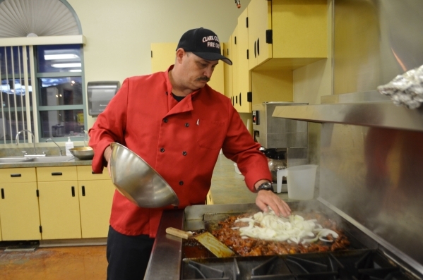 Aaron Smith wears a chef‘s jacket when he cooks at Clark County Fire Department Station 65. "It‘s not required, but over the years I‘ve ruined enough T-shirts to make a quil ...