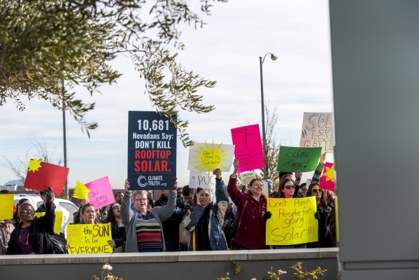 Solar energy supporters hold signs and chant during a rally at the PUC offices in Las Vegas on Wednesday, Jan. 13, 2016. Joshua Dahl/Las Vegas Review-Journal.