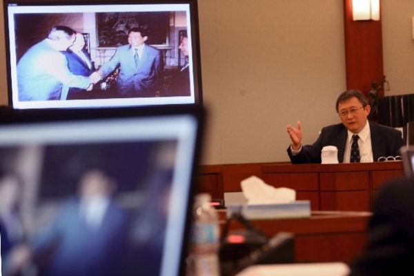 Hong Kong businessman Richard Suen testifies in 2013 at the Regional Justice Center in his lawsuit against Las Vegas Sands. The photo on the monitor shows Bill Weidner, left, former Las Vegas Sand ...