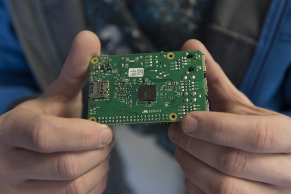 Kyle Kimsey holds a Raspberry Pi 2 chip that he plans to desolder and install into one of his drones in his workspace at his Las Vegas home Thursday, Jan. 14, 2016. Kimsey is the winner of the reg ...