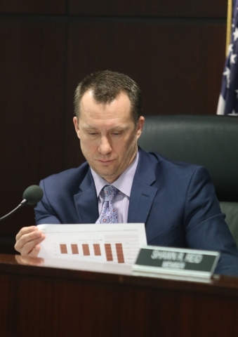 Gaming Control Board chairman A.G. Burnett looks over paperwork provided by Station Casinos during a hearing at Grant Sawyer building Thursday, Jan. 21, 2016, in Las Vegas. The board signed off on ...