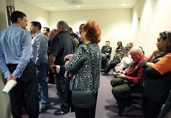 People, including Station Casinos employees and Culinary Union workers, wait outside a packed room where a Gaming Control Board hearing takes place at Grant Sawyer building Thursday, Jan. 21, 2016 ...