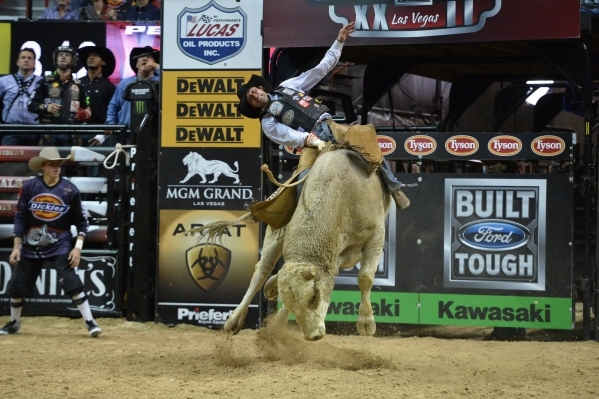 Ben Jones rides a bull during the 2015 PBR World Finals at the Thomas & Mack Center on Sunday, Oct. 25, 2015. Jones had to be back boarded out of the arena after being thrown off and trampled. ...