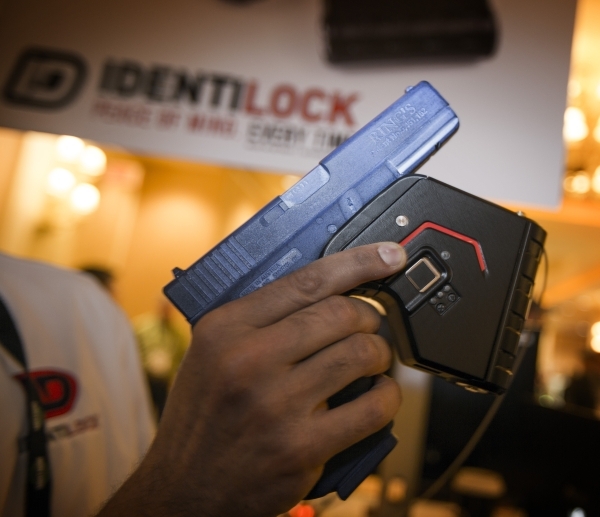 Omer Kiyani, founder of Identilock, holds the  gun lock he created during the Shot Show at the Sands Expo on Wednesday, Jan. 20, 2016. The biometric gunlock reads the shooter‘s finger prints ...
