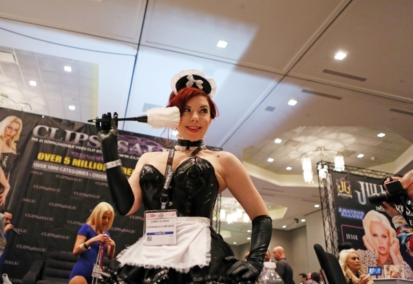 Entertainer Ludella Hahn poses for a show attendee at the Clips4Sale booth during the AVN Adult Entertainment Expo 2016 at Hard Rock hotel-casino Friday, Jan. 22, 2016, in Las Vegas. The four-day  ...