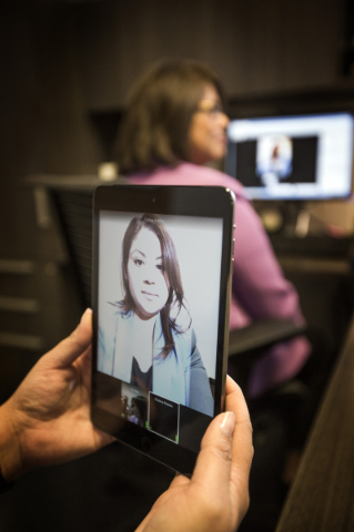 Fe Allen, director of talent acquisition for MGM Resorts, and Cristina Palafox, MGM Grand human resource associate, image on tablet, demonstrates the virtual interview at the corporate office, 840 ...