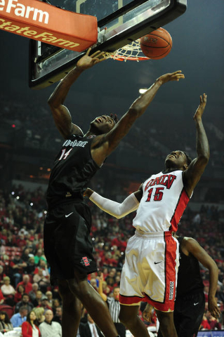 San Diego State forward Zylan Cheatham (14) and UNLV forward Dwayne Morgan (15) attempt to collect a rebound in the first half of their NCAA college basketball game at the Thomas & Mack Center ...