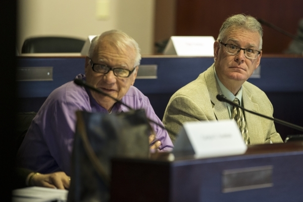 Dr. Larry Moses, left, and Henderson Mayor Andy Hafen, look at a presentation during a technical committee meeting to discuss the reorganization of the Clark County School District at the Grant Sa ...