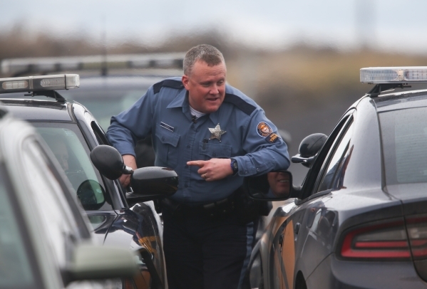 Oregon State Police talk with one another near a police roadblock outside of the Malheur National Wildlife Refuge, where four anti-government protestors remain, about 30 miles south of Burns, Ore. ...