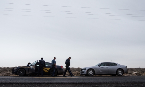 Oregon State Police gather near a police roadblock outside of the Malheur National Wildlife Refuge, where four anti-government protestors remain, about 30 miles south of Burns, Ore., on Thursday,  ...