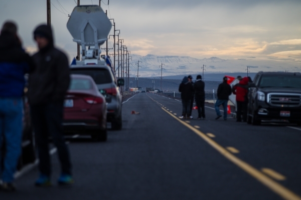 Members of the news media stand near a police roadblock outside of the Malheur National Wildlife Refuge, where four anti-government protestors remain, about 30 miles south of Burns, Ore., on Thurs ...
