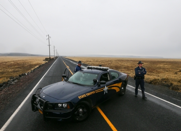 Oregon State Police block the road outside the Malheur National Wildlife Refuge, where four anti-government protesters remain, about 30 miles south of Burns, Ore., on Thursday, Jan. 28, 2016. Ammo ...