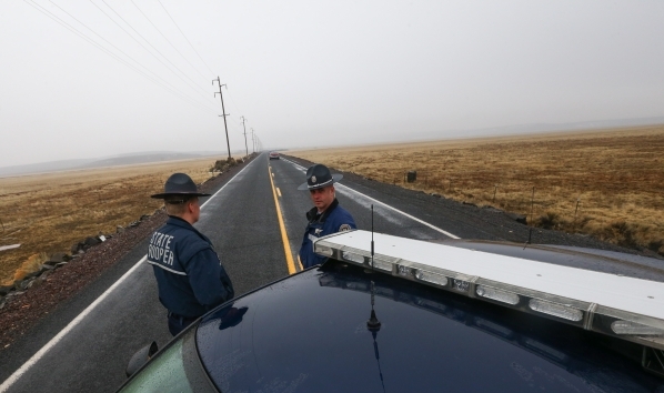 Oregon State Police block the road outside of the Malheur National Wildlife Refuge, where four anti-government protesters remain, about 30 miles south of Burns, Ore., on Thursday, Jan. 28, 2016. A ...