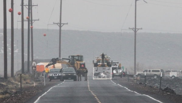 Heavy equipment is used to move concrete barriers at a roadblock outside of the Malheur National Wildlife Refuge, where four anti-government protesters remain, about 30 miles south of Burns, Ore., ...